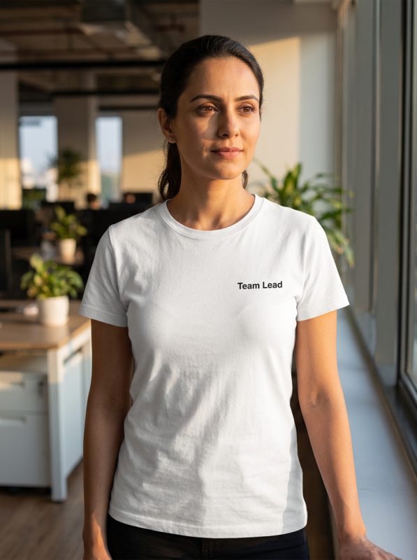 Team member wearing premium white t-shirt made in Thailand with role label for consistent team appearance